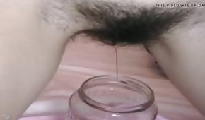 Chick is pissing in the jar