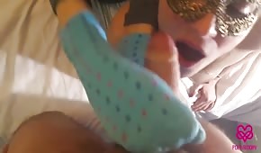 Babes in socks shake the cock with their feet